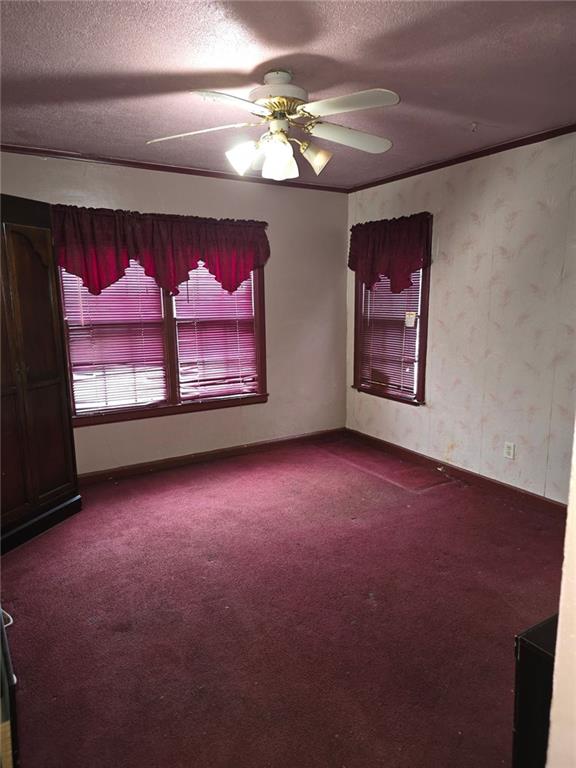 bedroom featuring crown molding and multiple windows