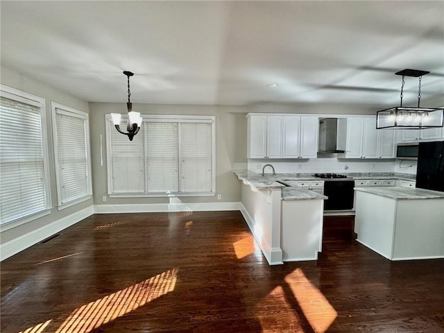 2822 Salem Oak Way, Duluth, GA 30096 - kitchen with wall chimney range hood, a chandelier, a peninsula, and pendant lighting