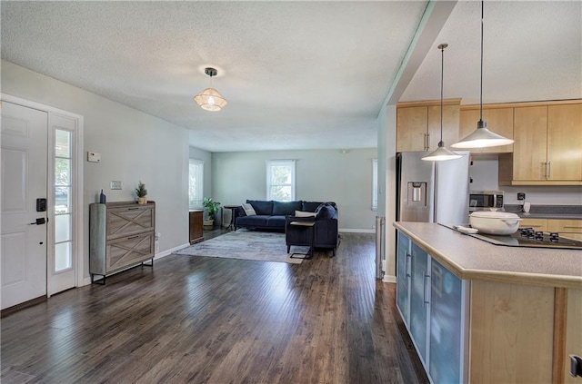 1837 Lochlomand Ln SE, Smyrna, GA 30080 - kitchen with light brown cabinets, stainless steel microwave, black electric stovetop, dark wood-style flooring, and a textured ceiling
