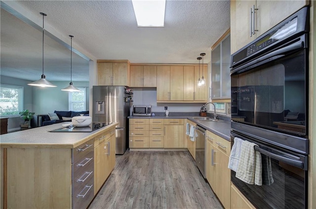 1837 Lochlomand Ln SE, Smyrna, GA 30080 - kitchen with light brown cabinetry, black appliances, a sink, light wood finished floors, and a textured ceiling