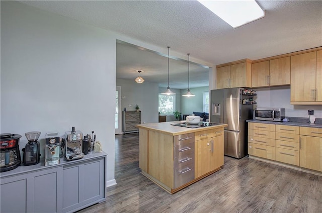 1837 Lochlomand Ln SE, Smyrna, GA 30080 - kitchen with stainless steel appliances, light brown cabinets, wood finished floors, a center island, and a textured ceiling