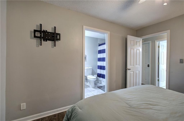 1837 Lochlomand Ln SE, Smyrna, GA 30080 - bedroom with baseboards, ensuite bathroom, a textured ceiling, and ceiling fan