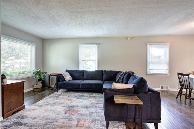1837 Lochlomand Ln SE, Smyrna, GA 30080 - living room with healthy amount of natural light, dark wood-style floors, baseboards, and a textured ceiling