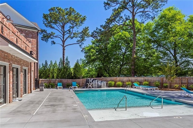 view of swimming pool with a patio area