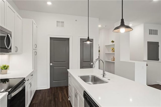 kitchen featuring sink, white cabinets, stainless steel appliances, and decorative light fixtures