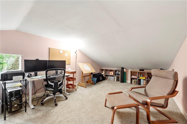 carpeted home office featuring vaulted ceiling