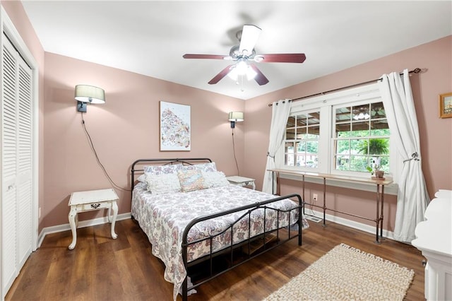 bedroom featuring a closet, wood finished floors, baseboards, and a ceiling fan