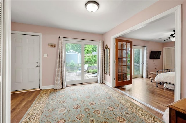 doorway to outside with wood finished floors, baseboards, and a healthy amount of sunlight