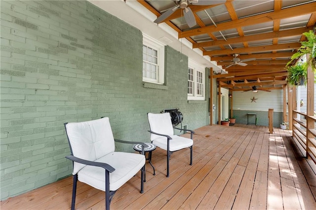wooden terrace featuring a ceiling fan