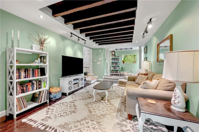 living room featuring track lighting, wood finished floors, and baseboards
