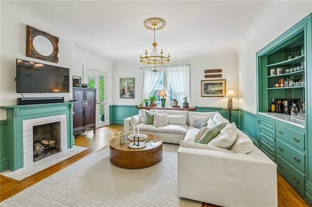 living area with an inviting chandelier and wood finished floors
