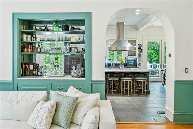 bar featuring arched walkways and indoor bar