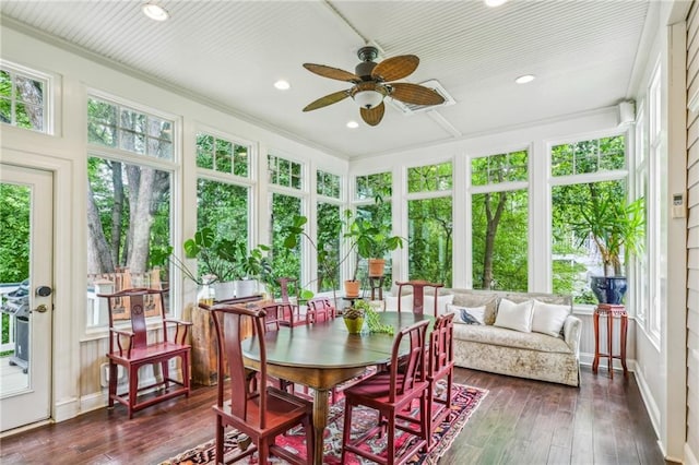 sunroom featuring wood-type flooring, recessed lighting, and a deck
