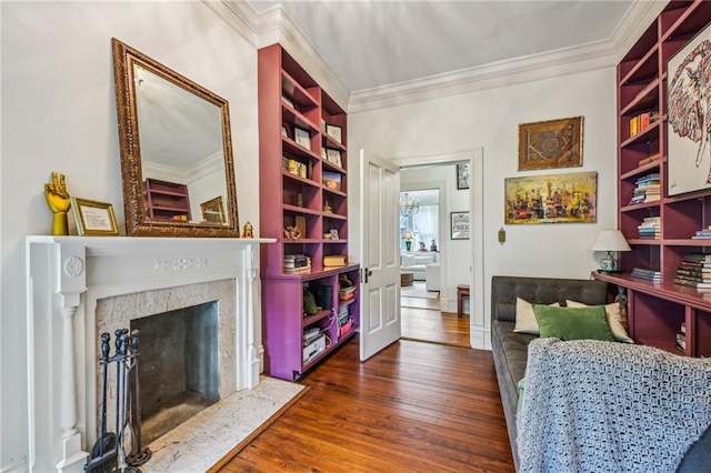 interior space with ornamental molding, a premium fireplace, and hardwood / wood-style flooring