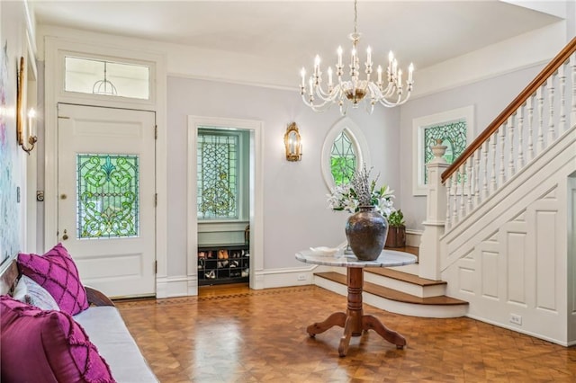 entryway featuring stairs and a notable chandelier