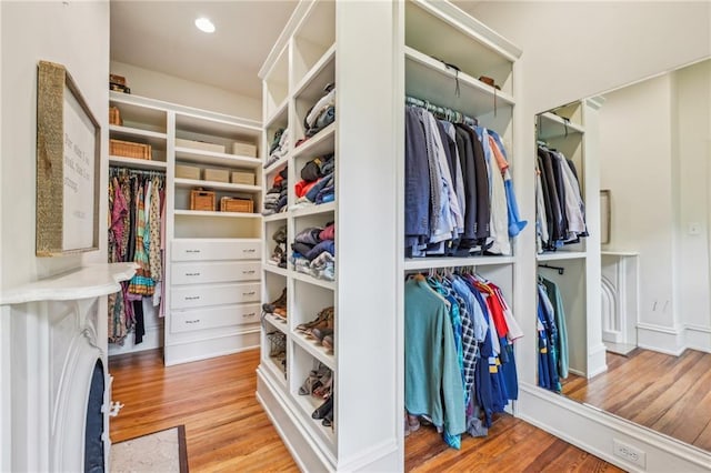 walk in closet with wood finished floors