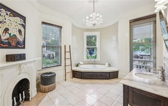 bathroom featuring tile patterned floors, a notable chandelier, a garden tub, and vanity