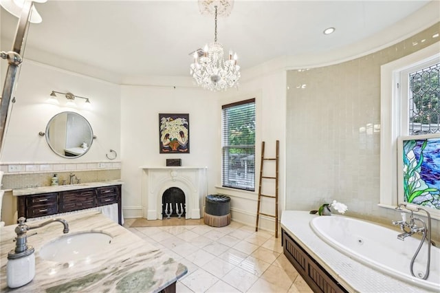 bathroom featuring a whirlpool tub, an inviting chandelier, two vanities, and a sink