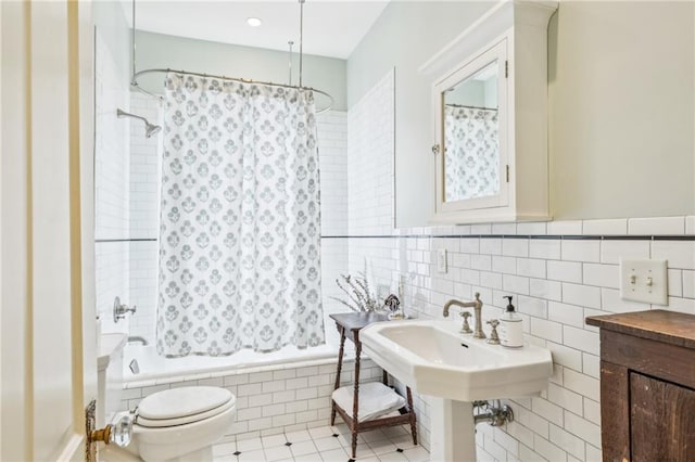 bathroom featuring toilet, tiled shower / bath, tile walls, and tile patterned flooring
