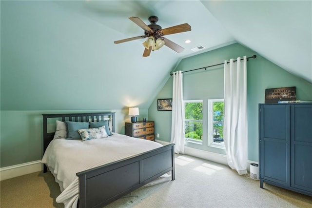 bedroom with a ceiling fan, light colored carpet, lofted ceiling, and visible vents
