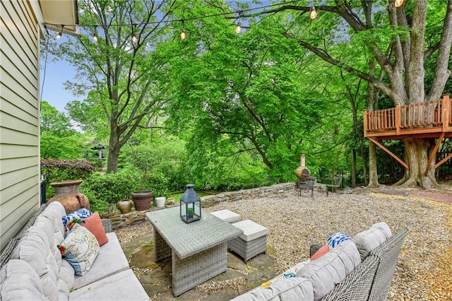 exterior space featuring a patio, outdoor lounge area, and a deck