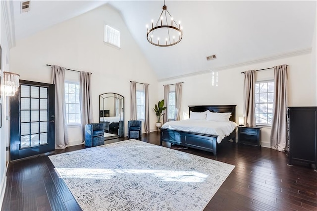 bedroom with multiple windows, dark wood-type flooring, and a notable chandelier