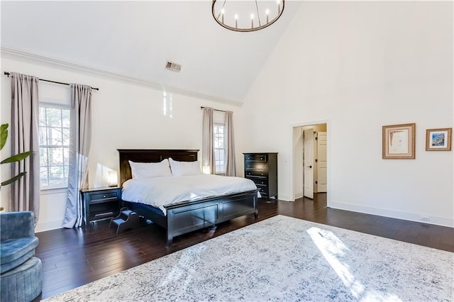 bedroom with dark hardwood / wood-style floors, high vaulted ceiling, and a notable chandelier