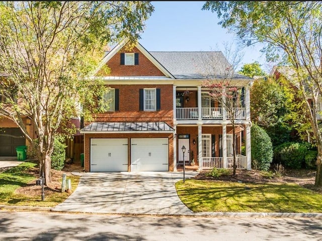 view of front of house featuring covered porch, a garage, and a front yard