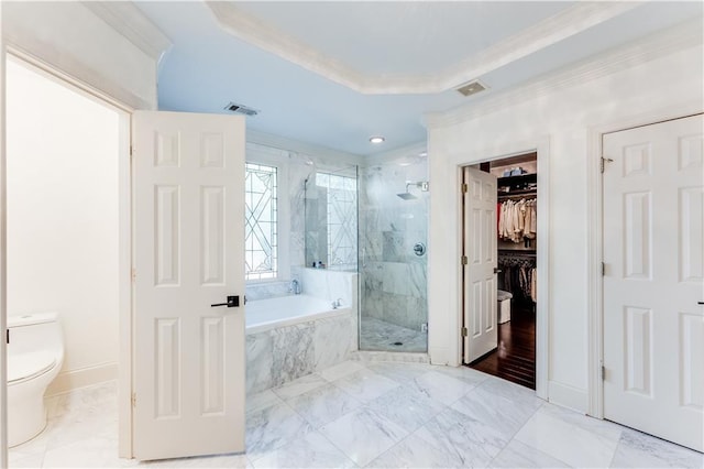 bathroom featuring plus walk in shower, a raised ceiling, toilet, and crown molding