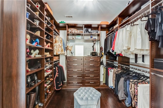 walk in closet with dark wood-type flooring