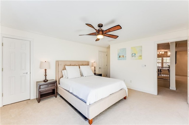 bedroom with ceiling fan and light colored carpet