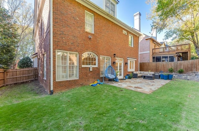 rear view of house featuring a lawn, a patio area, and outdoor lounge area