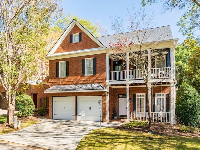 view of front of property featuring a porch, a garage, and a front lawn