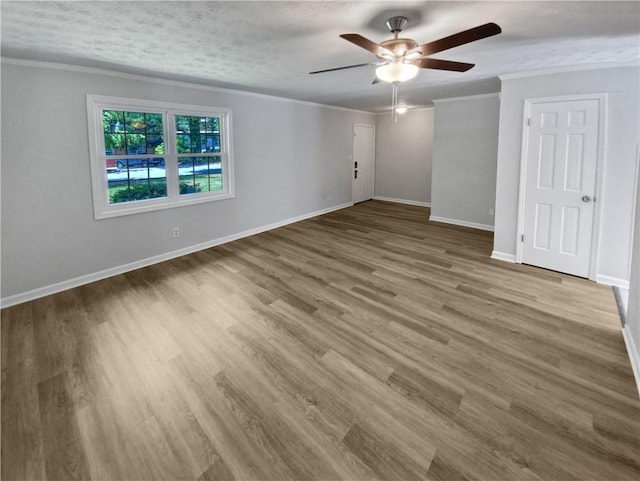 unfurnished room with a textured ceiling, wood-type flooring, ceiling fan, and crown molding