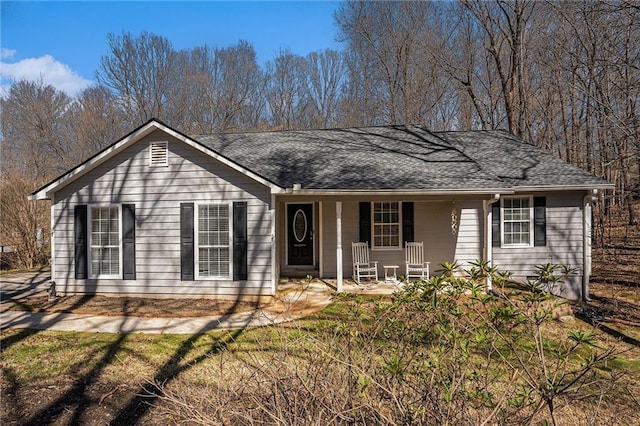 ranch-style home with covered porch and roof with shingles