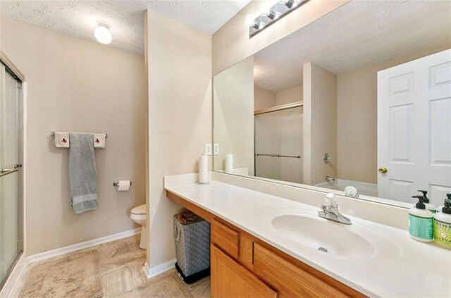 full bathroom with plus walk in shower, vanity, a textured ceiling, and toilet