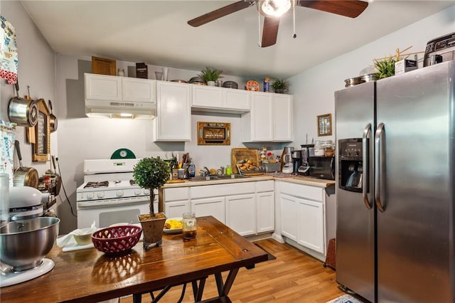 kitchen featuring stainless steel refrigerator with ice dispenser, sink, gas range gas stove, light hardwood / wood-style floors, and white cabinets