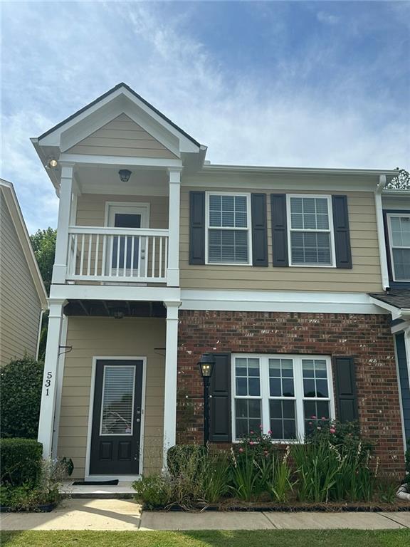 view of front of home featuring a balcony