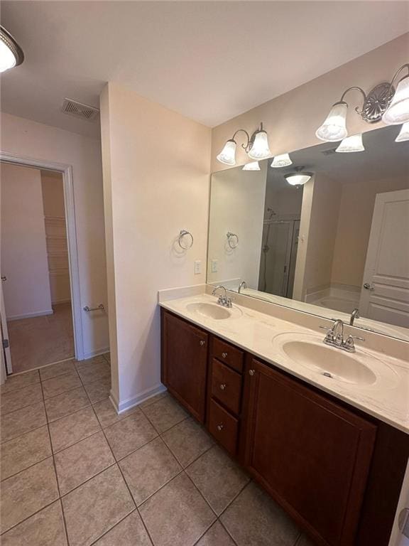 bathroom featuring shower with separate bathtub, tile patterned floors, and vanity