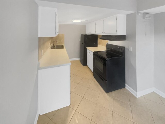 3541 Old Chamblee Tucker Rd Unit G, Atlanta, GA 30340 - kitchen featuring under cabinet range hood, light countertops, black appliances, a sink, and baseboards