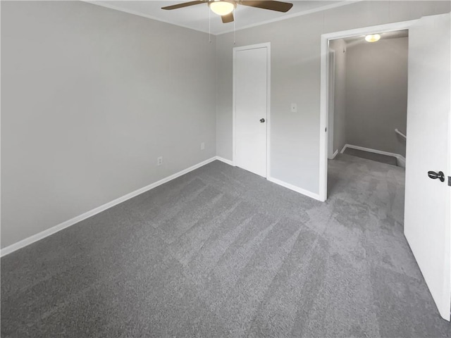 unfurnished bedroom featuring dark colored carpet, a closet, and ceiling fan