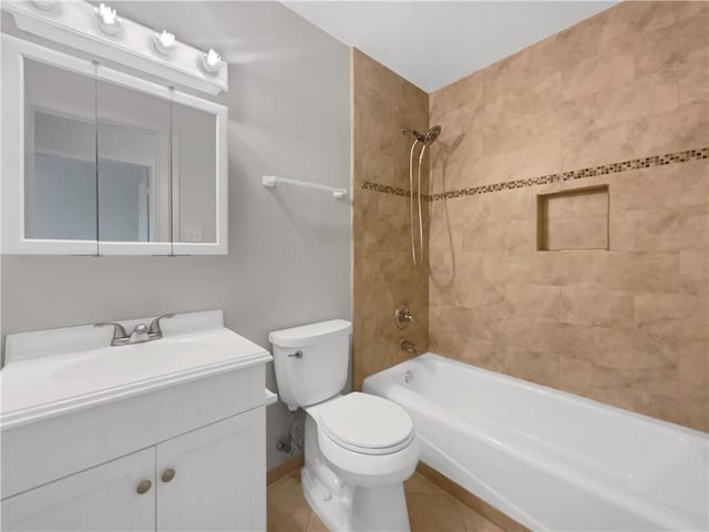 full bathroom featuring vanity, toilet, tile patterned floors, and tiled shower / bath combo