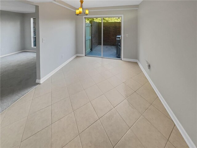 3541 Old Chamblee Tucker Rd Unit G, Atlanta, GA 30340 - unfurnished dining area with tile patterned flooring, an inviting chandelier, and baseboards