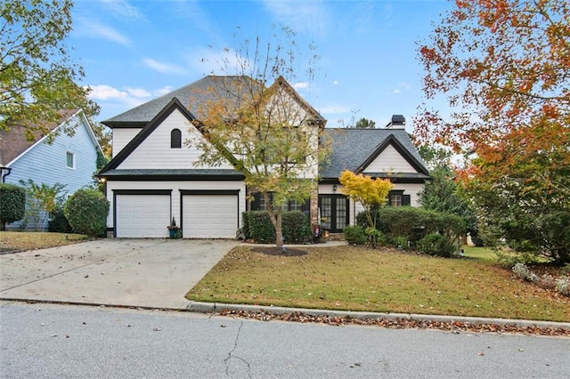 view of front of property with a front lawn and a garage