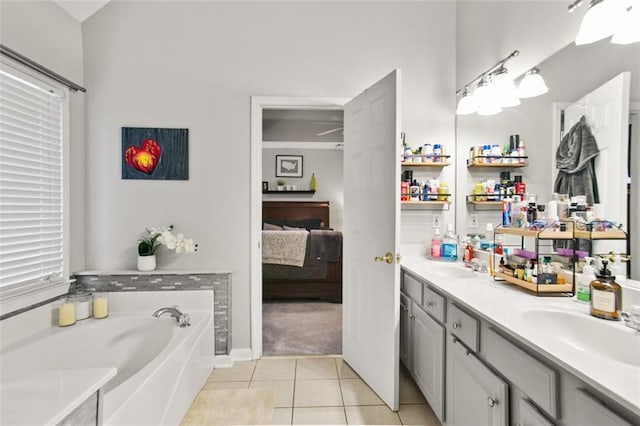 bathroom featuring vanity, tile patterned floors, and a tub