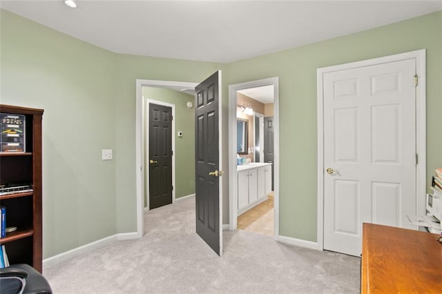 carpeted bedroom featuring ensuite bath