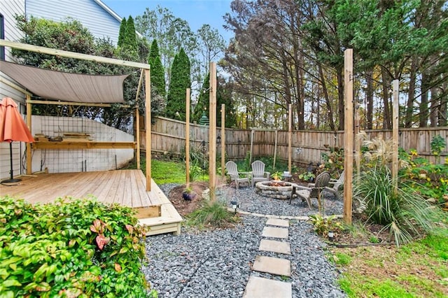 view of yard with an outdoor fire pit and a deck