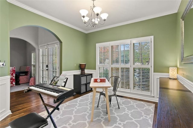 miscellaneous room with wood-type flooring, crown molding, and a chandelier