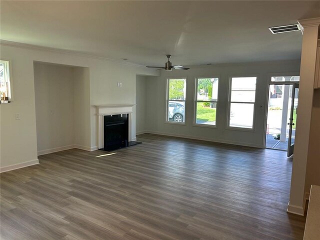 241 Saratoga Dr, Acworth, GA 30102 - unfurnished living room featuring a fireplace with raised hearth, dark wood-style flooring, ceiling fan, baseboards, and ornamental molding