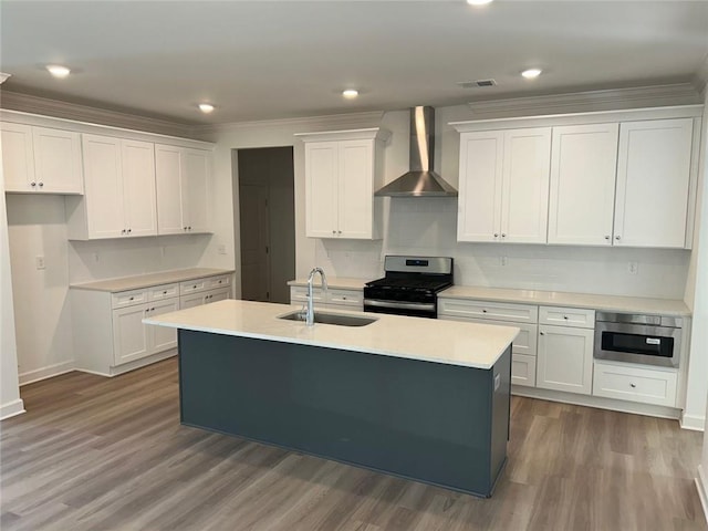 241 Saratoga Dr, Acworth, GA 30102 - kitchen featuring wall chimney range hood, range with gas stovetop, a sink, white cabinets, and an island with sink